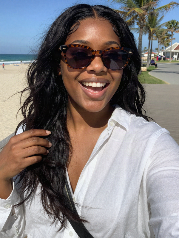 Beach selfie with a black loose wave wig blowing in the breeze