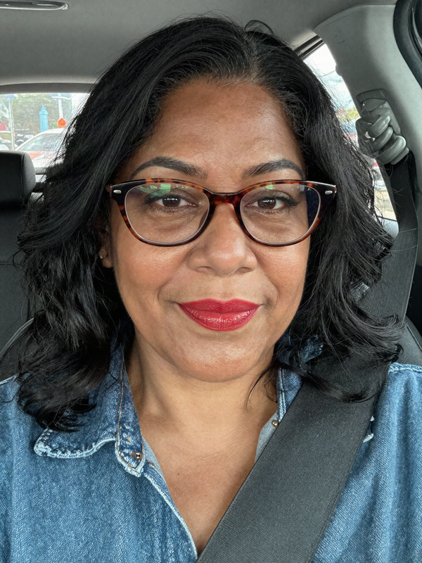 Car selfie wearing a black loose wave wig with a side part