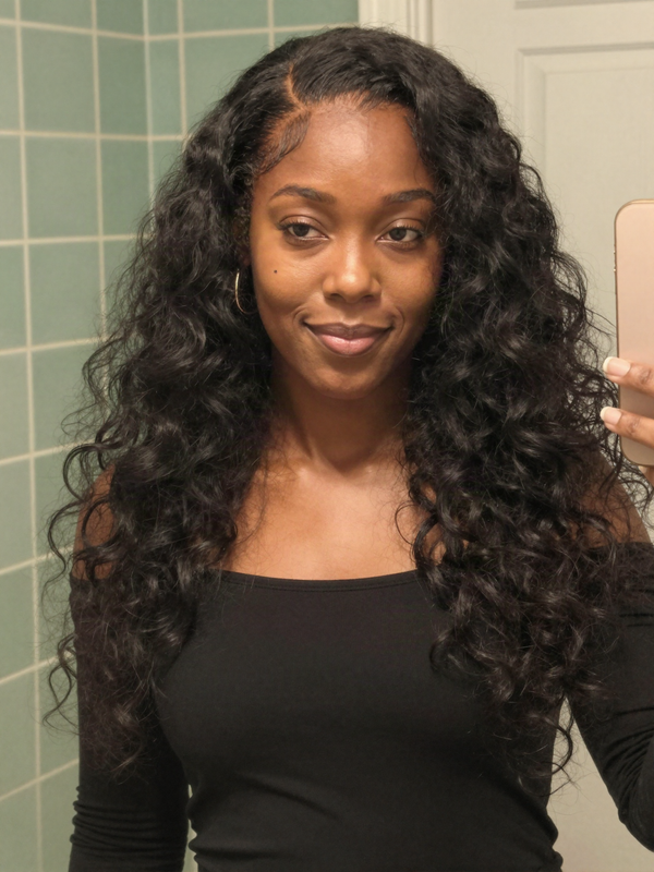 Black human hair wig styled into big curls for a night out