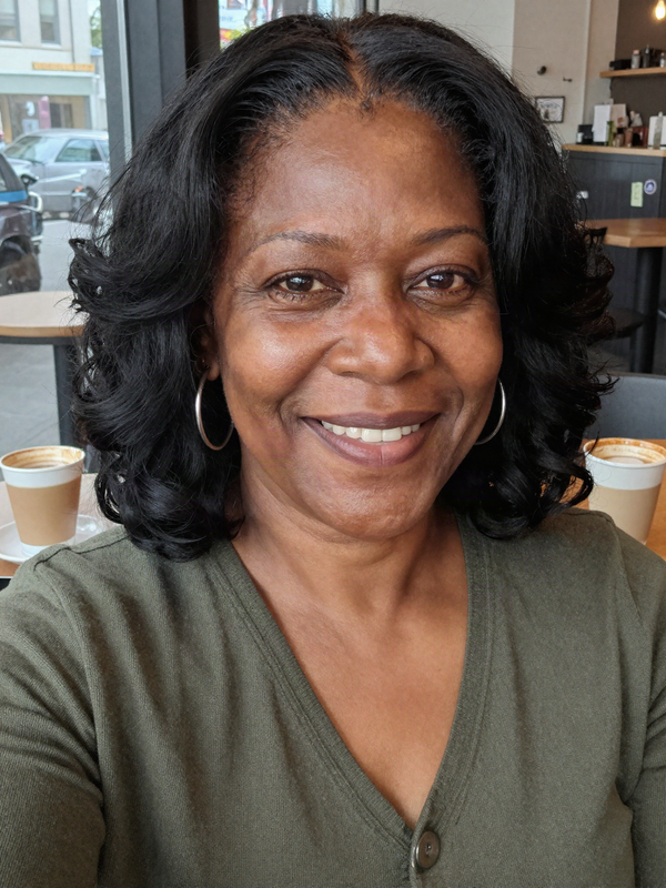 Coffee shop selfie wearing a shoulder-length black loose wave wig